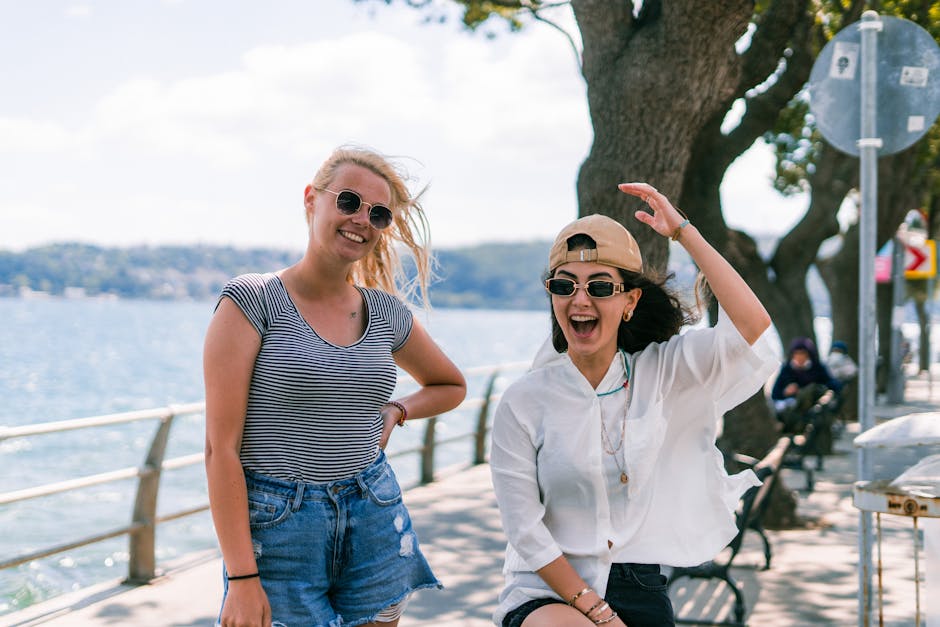 Two women enjoying a sunny day by the Bosphorus in Istanbul, showcasing friendship and summer vibes.