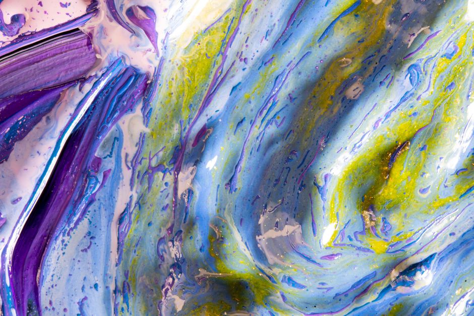 Dynamic abstract artwork featuring swirling blue, green, and purple colors.