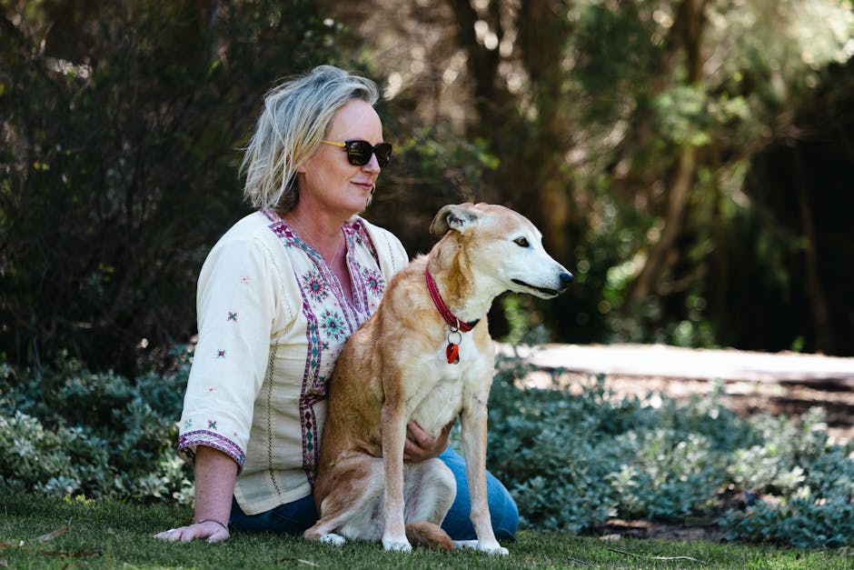 A woman enjoys a tranquil day outdoors with her dog at Bibra Lake, Western Australia.